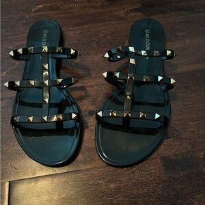 Black and gold jelly slip ons